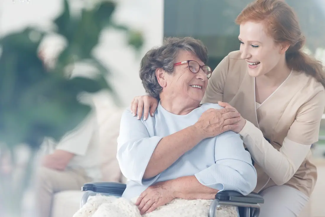 Older woman smiling with her carer