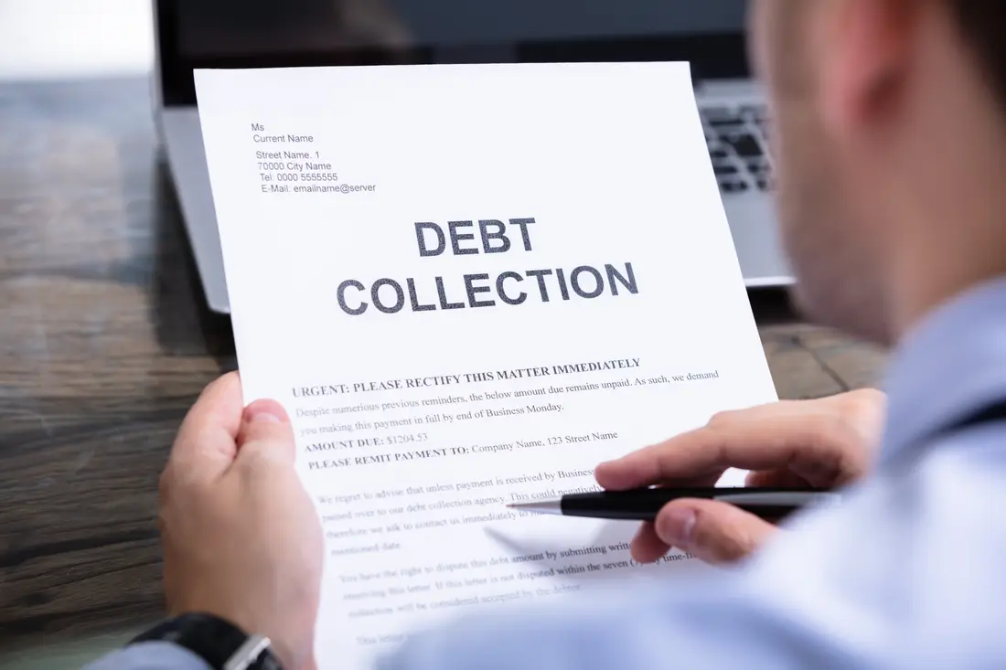 Man reading a debt collection letter