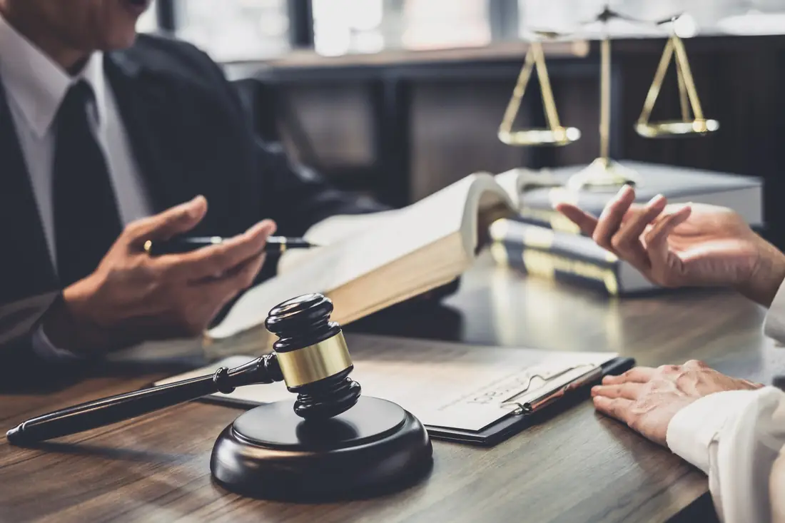 Solicitor meeting a client at a desk