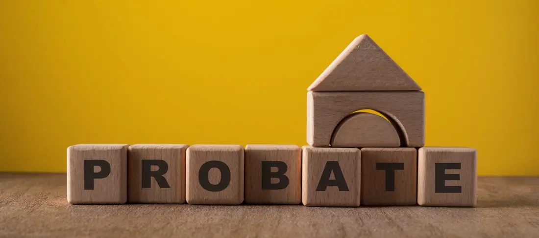 Wooden blocks spelling probate with a block house